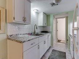 2624 N Ann Arbor St Unit 106, Oklahoma City, OK 73127 - kitchen with tasteful backsplash and a sink