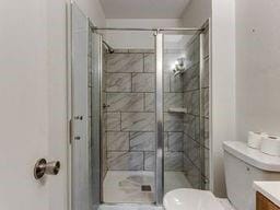2624 N Ann Arbor St Unit 106, Oklahoma City, OK 73127 - full bathroom with toilet, a stall shower, and vanity