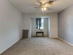 2624 N Ann Arbor St Unit 106, Oklahoma City, OK 73127 - spare room featuring a ceiling fan and baseboards