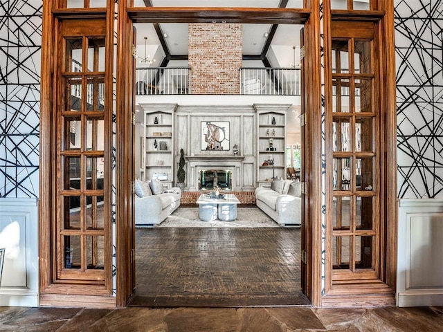 living room featuring a brick fireplace and vaulted ceiling
