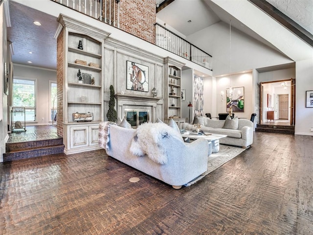 living room featuring a fireplace, baseboards, recessed lighting, high vaulted ceiling, and crown molding