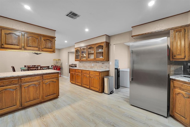 11747 N 2240th Rd, Cordell, OK 73632 - kitchen featuring stainless steel fridge, brown cabinets, backsplash, and recessed lighting