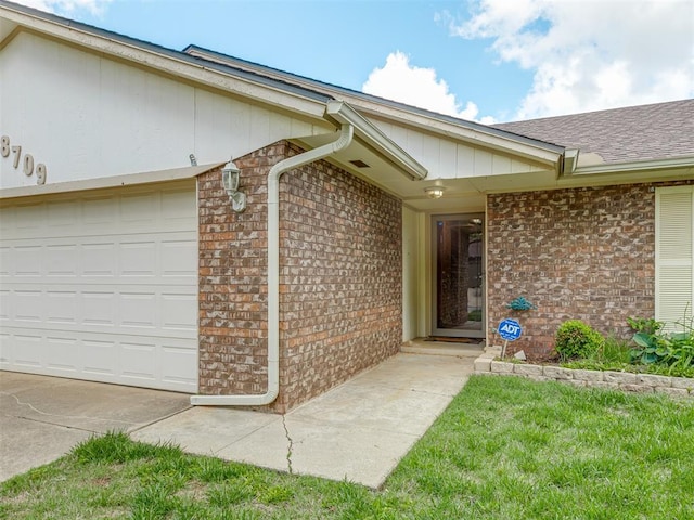 8709 NW 86th St, Oklahoma City, OK 73132 - doorway to property featuring brick siding, roof with shingles, and a garage