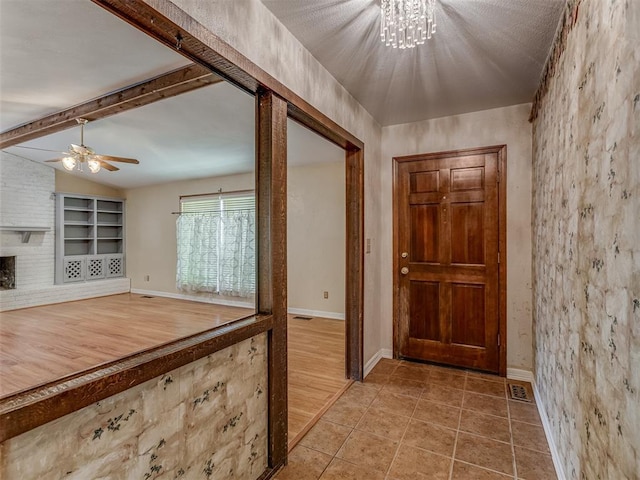 8709 NW 86th St, Oklahoma City, OK 73132 - foyer entrance featuring ceiling fan, baseboards, a chandelier, and tile patterned floors