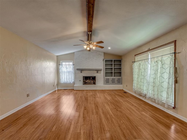8709 NW 86th St, Oklahoma City, OK 73132 - unfurnished living room featuring a ceiling fan, wood finished floors, a brick fireplace, and baseboards