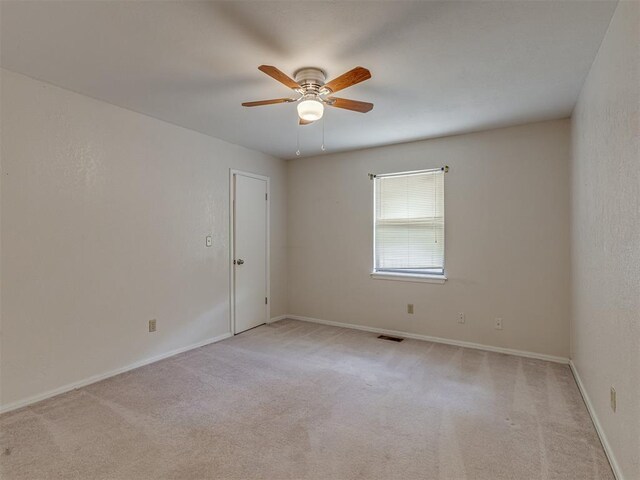 8709 NW 86th St, Oklahoma City, OK 73132 - empty room featuring ceiling fan, light carpet, and baseboards