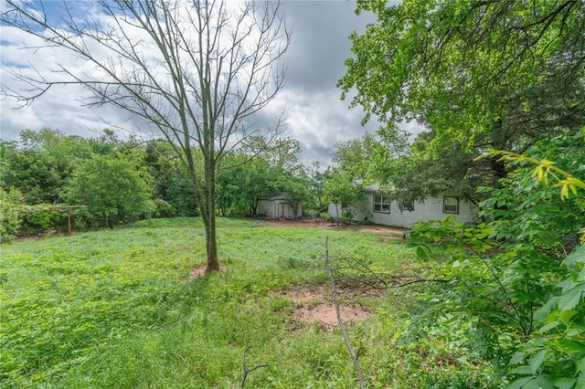 39761 State Highway 59, Byars, OK 74831 - view of green lawn featuring a storage unit and an outbuilding