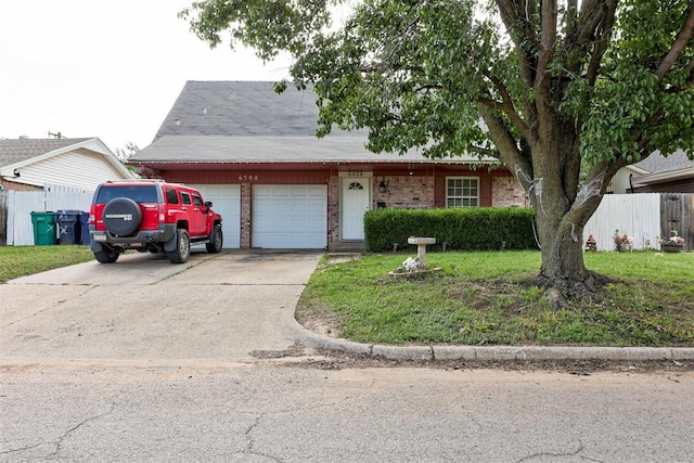 6508 S Harvey Ave, Oklahoma City, OK 73139 - view of front facade with an attached garage, brick siding, and driveway
