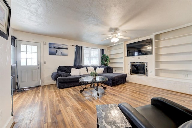 6508 S Harvey Ave, Oklahoma City, OK 73139 - living room with healthy amount of natural light, a textured ceiling, ceiling fan, and wood finished floors