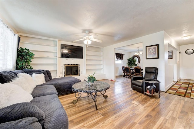 6508 S Harvey Ave, Oklahoma City, OK 73139 - living area featuring a ceiling fan, light wood finished floors, baseboards, and a chandelier
