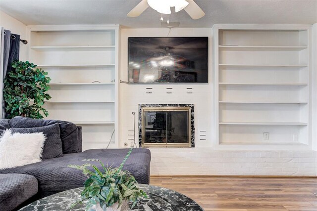 6508 S Harvey Ave, Oklahoma City, OK 73139 - living room featuring wood finished floors, a ceiling fan, and a glass covered fireplace