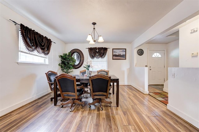 6508 S Harvey Ave, Oklahoma City, OK 73139 - dining space featuring a chandelier, light wood finished floors, and baseboards