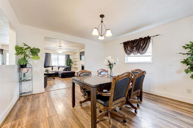 6508 S Harvey Ave, Oklahoma City, OK 73139 - dining space with light wood finished floors, baseboards, and a chandelier