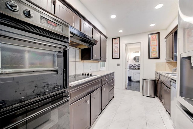 6508 S Harvey Ave, Oklahoma City, OK 73139 - kitchen with double wall oven, black electric cooktop, under cabinet range hood, recessed lighting, and decorative backsplash