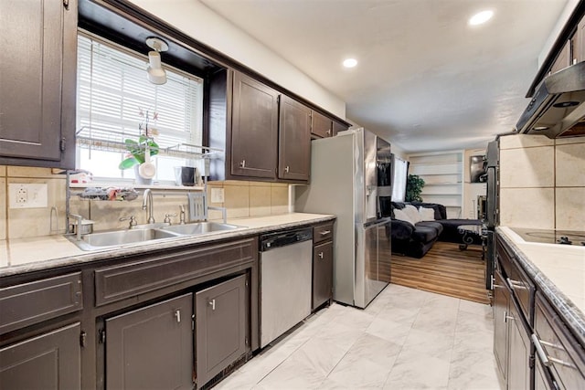 6508 S Harvey Ave, Oklahoma City, OK 73139 - kitchen featuring stainless steel appliances, dark brown cabinetry, a sink, light countertops, and decorative backsplash