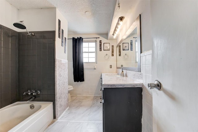 6508 S Harvey Ave, Oklahoma City, OK 73139 - bathroom featuring tile walls, toilet, vanity, a textured ceiling, and wainscoting