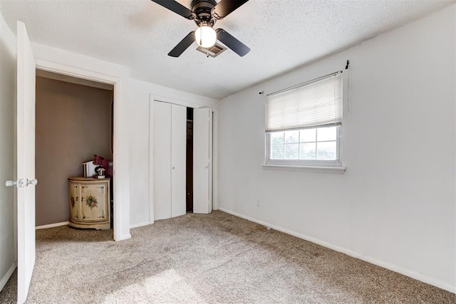 6508 S Harvey Ave, Oklahoma City, OK 73139 - unfurnished bedroom with carpet, a textured ceiling, a closet, baseboards, and a ceiling fan