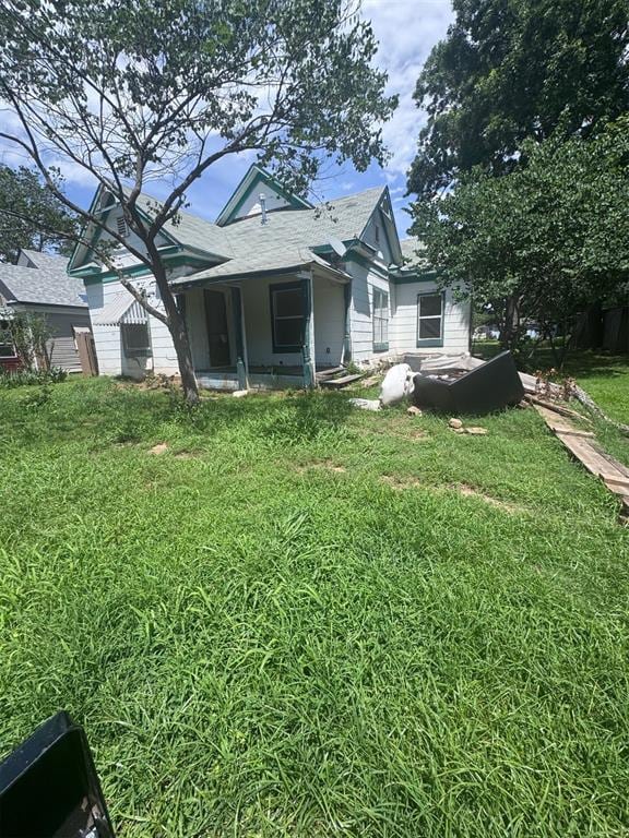 315 S Culver Ave, Meeker, OK 74855 - back of house featuring a lawn and roof with shingles