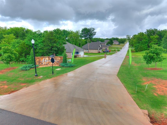 view of home's community with a yard and driveway