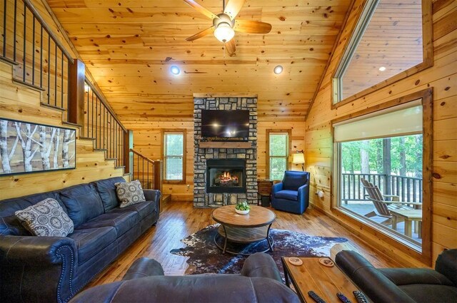 479 Poplar Cir, Broken Bow, OK 74728 - living room with wood ceiling, hardwood / wood-style flooring, wooden walls, a ceiling fan, and a fireplace