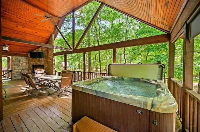 479 Poplar Cir, Broken Bow, OK 74728 - deck with a hot tub, a fireplace, outdoor dining area, and a ceiling fan