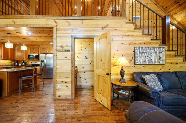 479 Poplar Cir, Broken Bow, OK 74728 - living area with wood walls, hardwood / wood-style flooring, stairway, and wooden ceiling