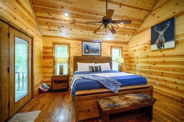 479 Poplar Cir, Broken Bow, OK 74728 - bedroom with vaulted ceiling, wood finished floors, wooden walls, multiple windows, and wooden ceiling