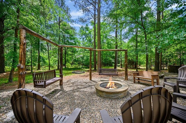 479 Poplar Cir, Broken Bow, OK 74728 - view of patio / terrace featuring an outdoor fire pit and view of scattered trees