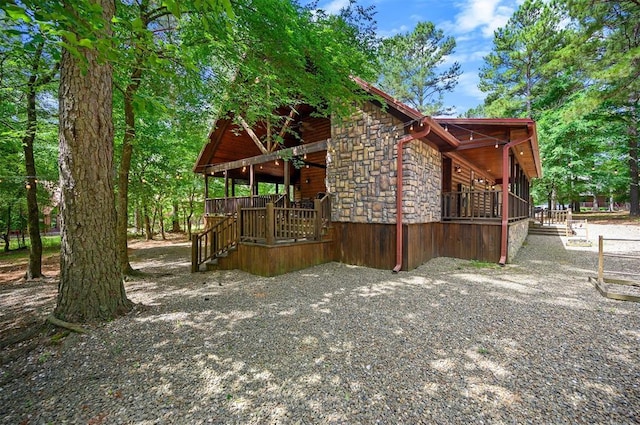 479 Poplar Cir, Broken Bow, OK 74728 - view of property exterior featuring stone siding and a porch
