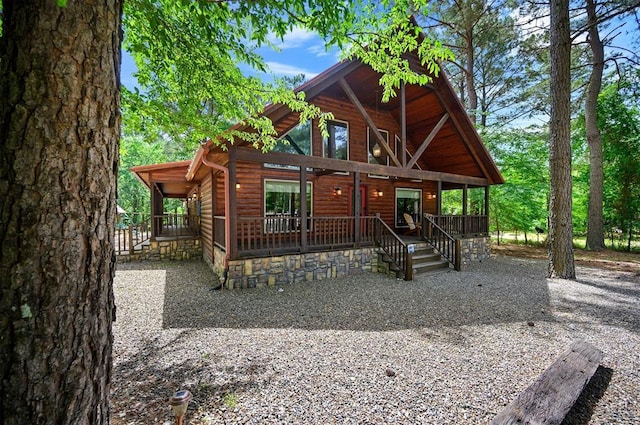 479 Poplar Cir, Broken Bow, OK 74728 - rustic home featuring faux log siding and a porch