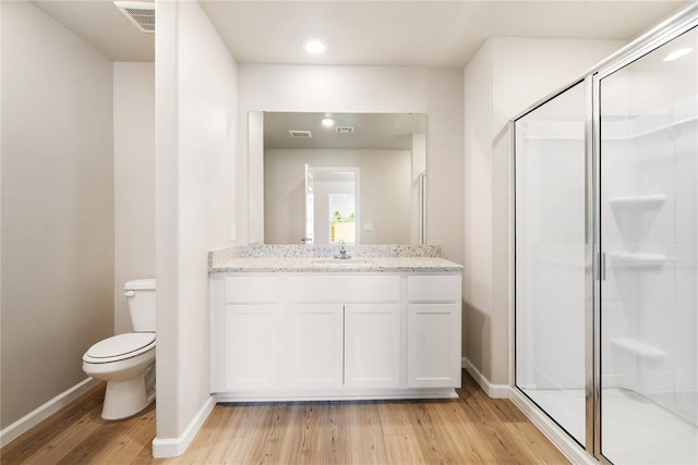 full bathroom with wood finished floors, a stall shower, toilet, baseboards, and recessed lighting