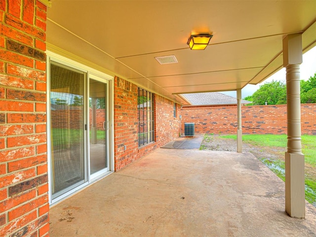 10021 Henderson Dr, Oklahoma City, OK 73139 - view of patio featuring central air condition unit and fence