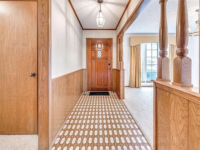 10021 Henderson Dr, Oklahoma City, OK 73139 - entryway with ornamental molding, wainscoting, wooden walls, carpet floors, and wallpapered walls