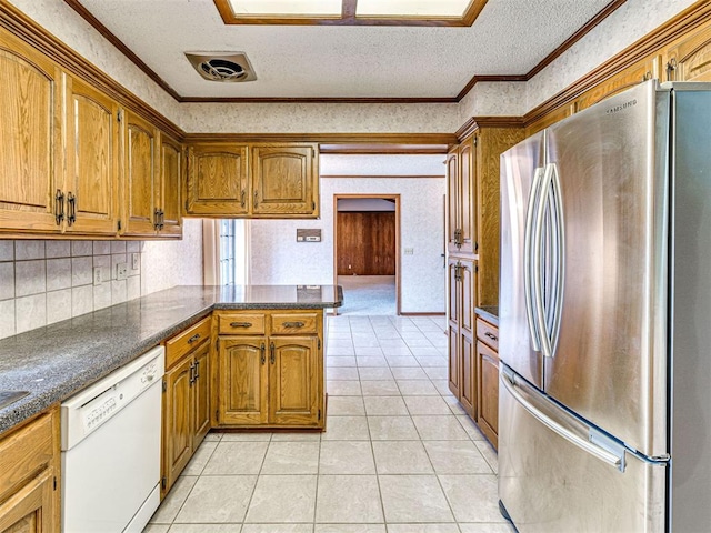10021 Henderson Dr, Oklahoma City, OK 73139 - kitchen featuring freestanding refrigerator, white dishwasher, a textured ceiling, crown molding, and a peninsula