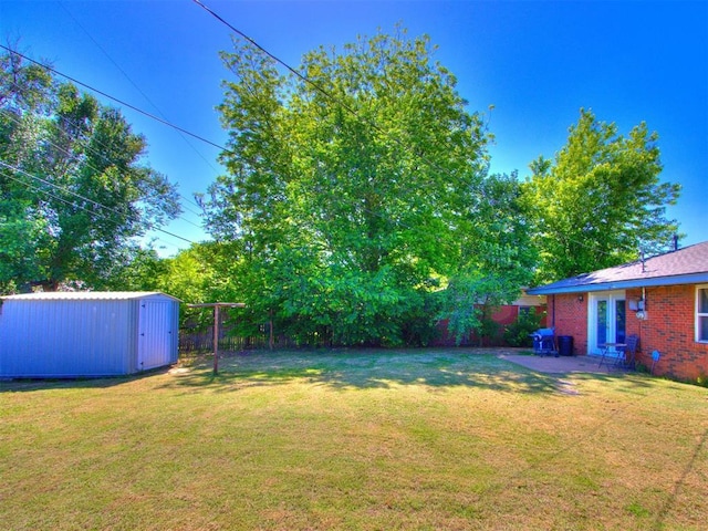 4704 Lisa Ln, Oklahoma City, OK 73115 - fenced backyard featuring a storage shed and a patio