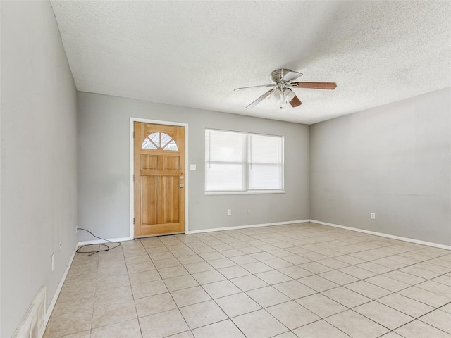 4704 Lisa Ln, Oklahoma City, OK 73115 - entryway with a ceiling fan, a textured ceiling, and light tile patterned floors