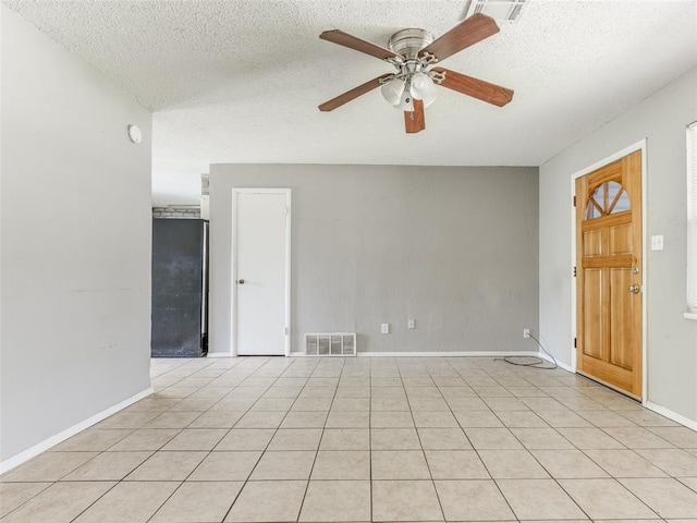 4704 Lisa Ln, Oklahoma City, OK 73115 - empty room featuring a ceiling fan, a textured ceiling, and light tile patterned floors