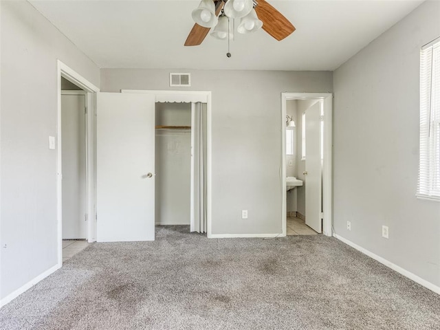 4704 Lisa Ln, Oklahoma City, OK 73115 - unfurnished bedroom with carpet floors, a closet, a ceiling fan, and ensuite bathroom
