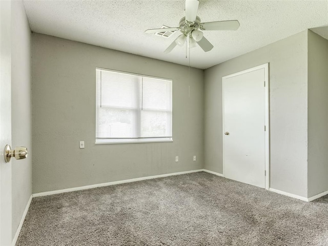 4704 Lisa Ln, Oklahoma City, OK 73115 - empty room featuring carpet flooring, ceiling fan, and a textured ceiling