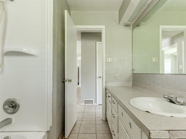 4704 Lisa Ln, Oklahoma City, OK 73115 - full bath featuring tile patterned floors, vanity, and shower / bath combination