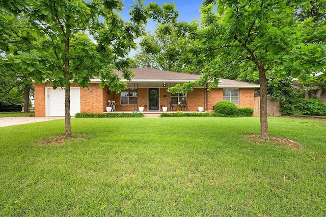 ranch-style home with covered porch, concrete driveway, a front yard, and a garage