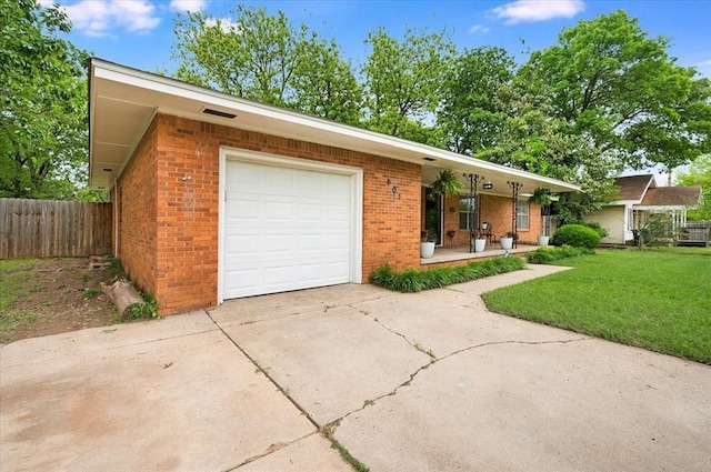 single story home with covered porch, an attached garage, brick siding, and driveway