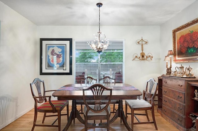 dining area with a chandelier and light wood-style floors