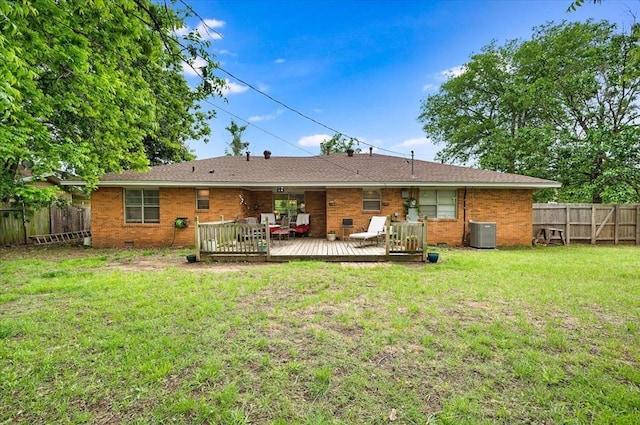 rear view of property featuring central AC unit, brick siding, and a deck