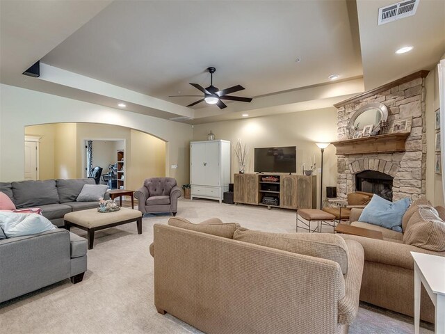 15101 SE 58th St, Choctaw, OK 73020 - living area featuring a tray ceiling, light colored carpet, arched walkways, ceiling fan, and recessed lighting