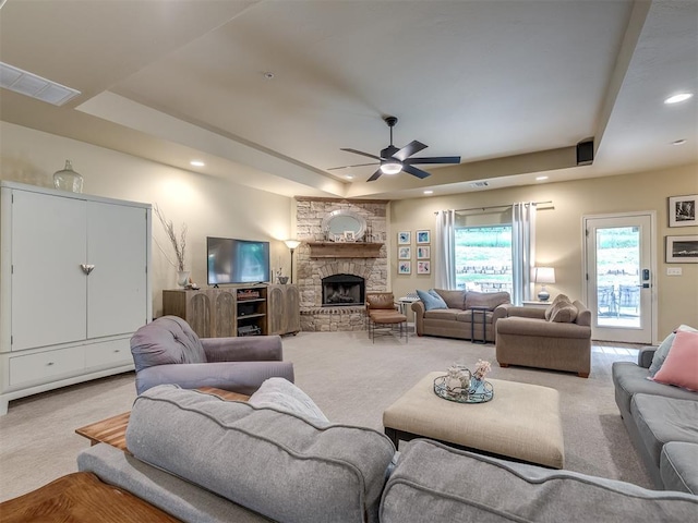 15101 SE 58th St, Choctaw, OK 73020 - carpeted living room with a raised ceiling, ceiling fan, recessed lighting, and a fireplace