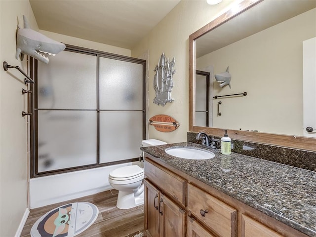 15101 SE 58th St, Choctaw, OK 73020 - bathroom featuring wood finished floors, vanity, toilet, and combined bath / shower with glass door