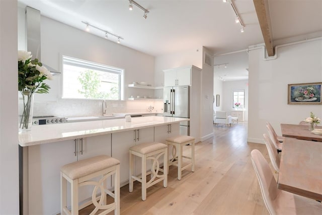 614 NW 8th St Unit 1-4, Oklahoma City, OK 73102 - kitchen with track lighting, high end refrigerator, a sink, backsplash, and a peninsula