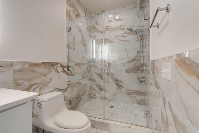 614 NW 8th St Unit 1-4, Oklahoma City, OK 73102 - bathroom with tile walls, toilet, a marble finish shower, and vanity