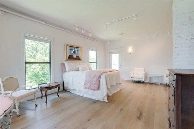 614 NW 8th St Unit 1-4, Oklahoma City, OK 73102 - bedroom featuring rail lighting and multiple windows